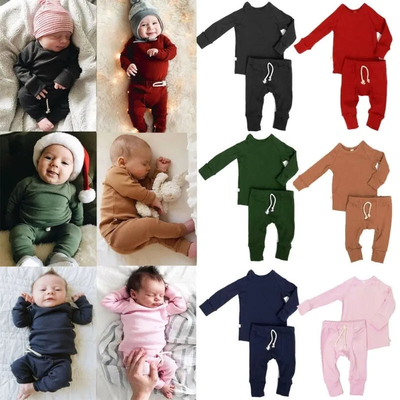 Blue cotton baby tracksuit romper set with cartoon pattern, shown on a hanger.