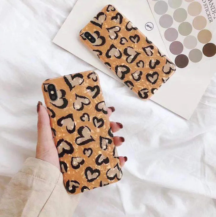 Leopard print silicone protective case for iPhone on a table.