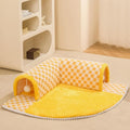 Large plush fan-shaped dog and cat bed with central tunnel, in coffee colour, on a floor.