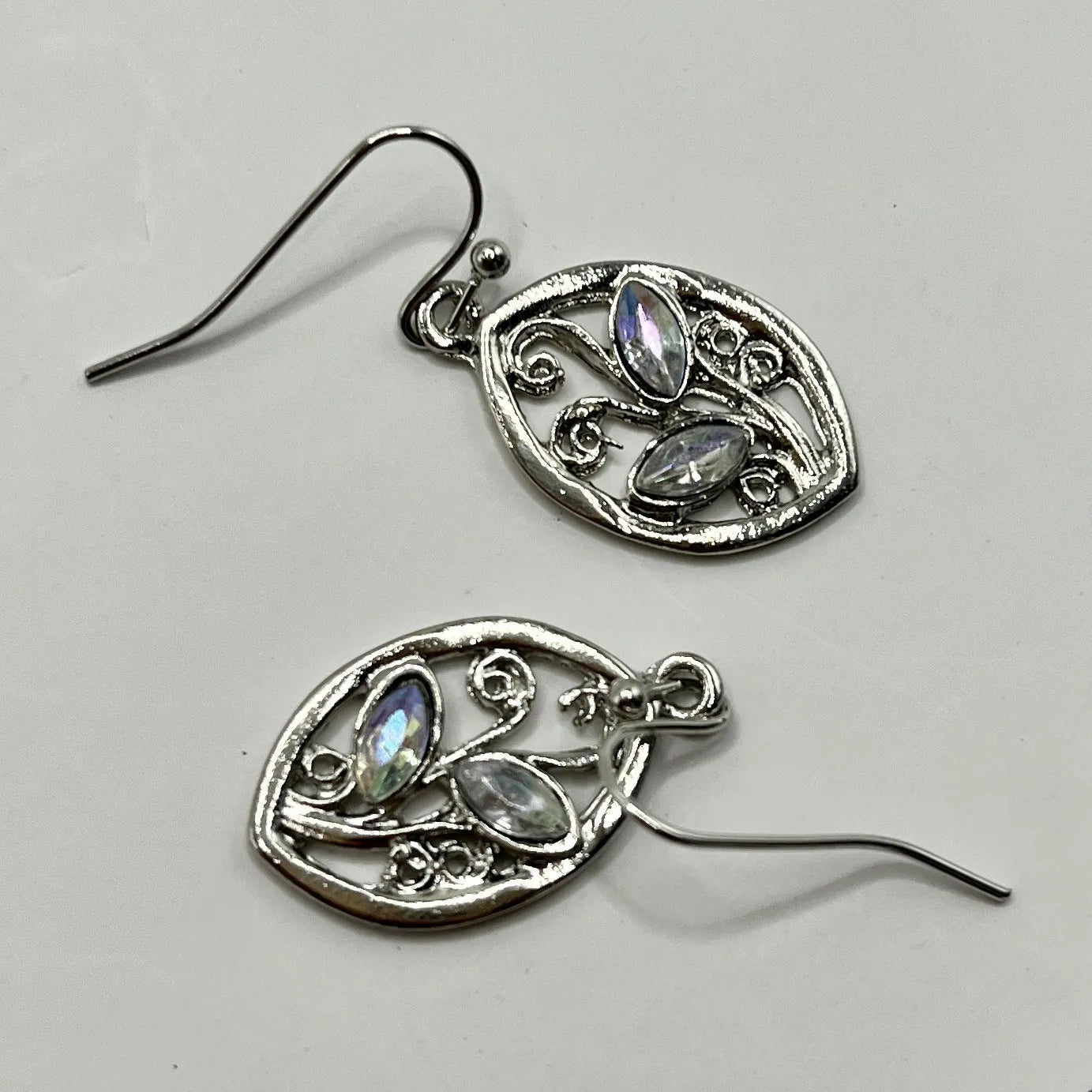 Silver colour leaf-shaped earrings with embedded colourful moonstones and European design elements