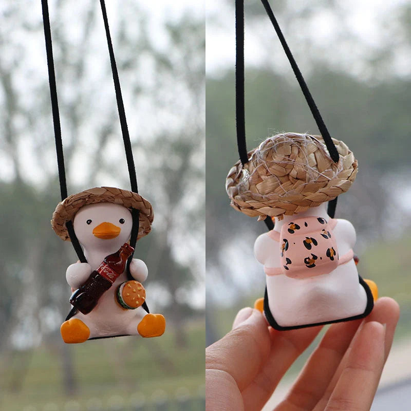Swing Duck Car Pendant hanging from a rearview mirror, showcasing vibrant colors and unique design