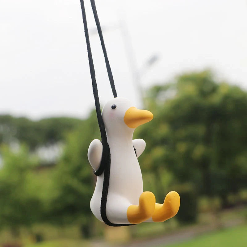 Swing Duck Car Pendant hanging from a rearview mirror, showcasing vibrant colors and unique design
