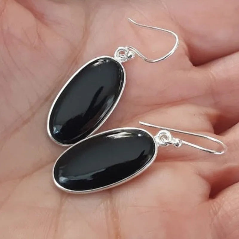 Women's geometric earrings with black agate oval pendants and silver electroplated finish