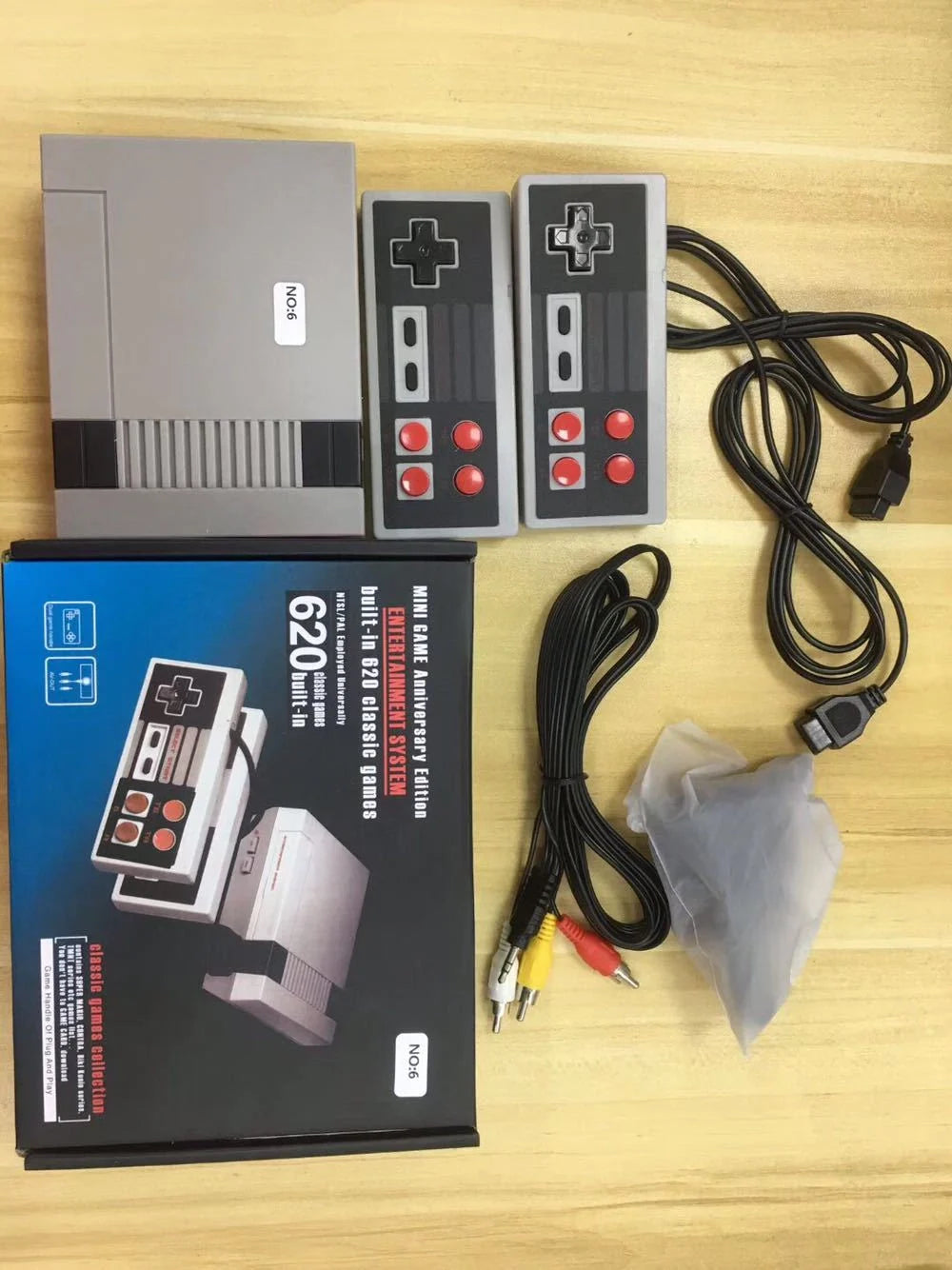 620 Classic Games Console with two joystick controllers on a wooden table