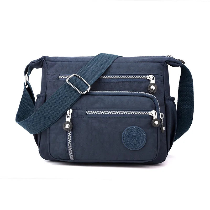 Lightweight grey nylon shoulder messenger bag with a single strap, shown in a square vertical shape.
