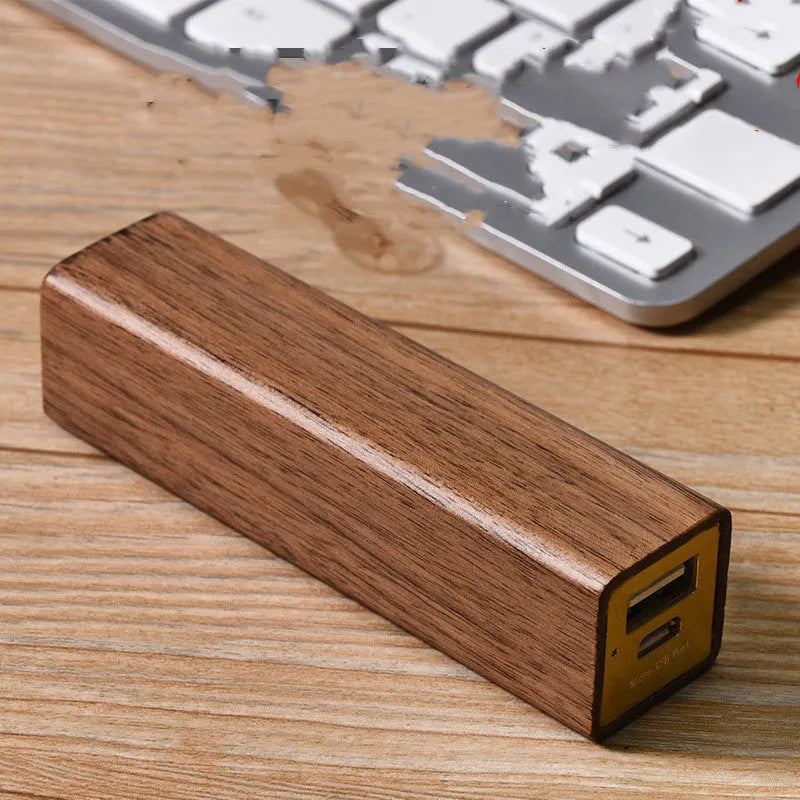 Black walnut wood portable power bank showing wooden casing with USB port and dimensions of 100mm x 25mm x 25mm