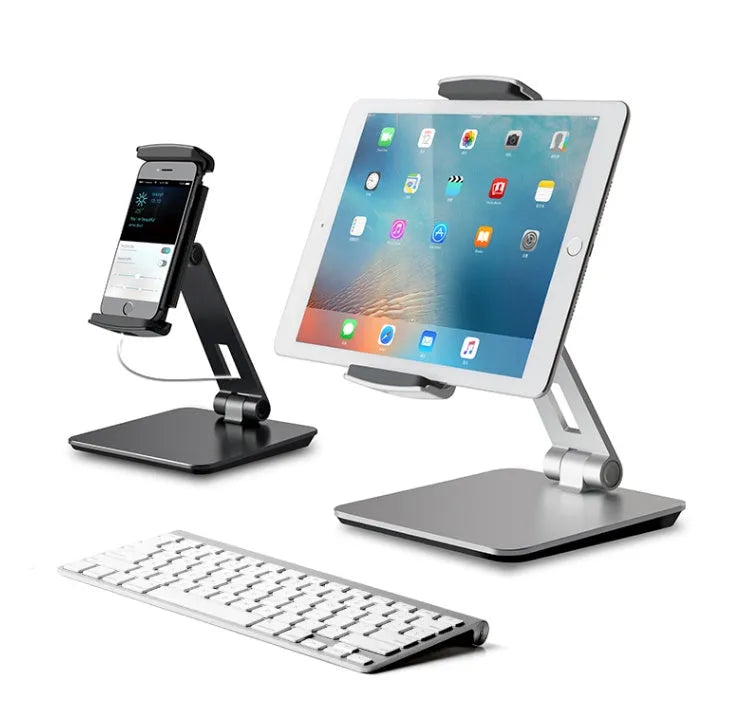 Silver aluminium foldable desktop stand holding a tablet, showing 360-degree rotation.