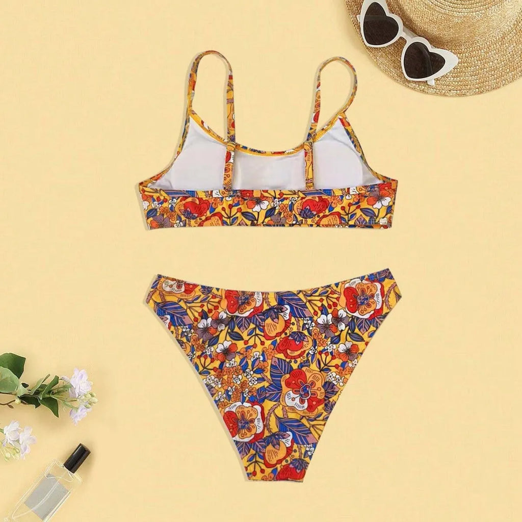 Plus size women's floral print bikini swimsuit with strap design on white background
