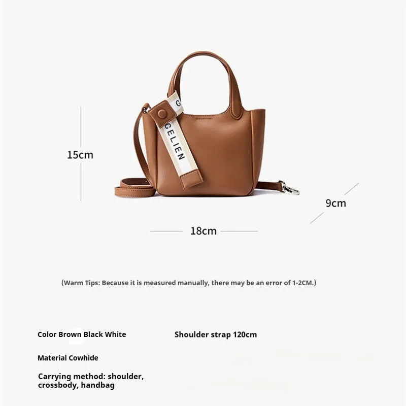 Brown genuine cattlehide leather cross body bucket bag showing sewing thread detail and slit pocket.