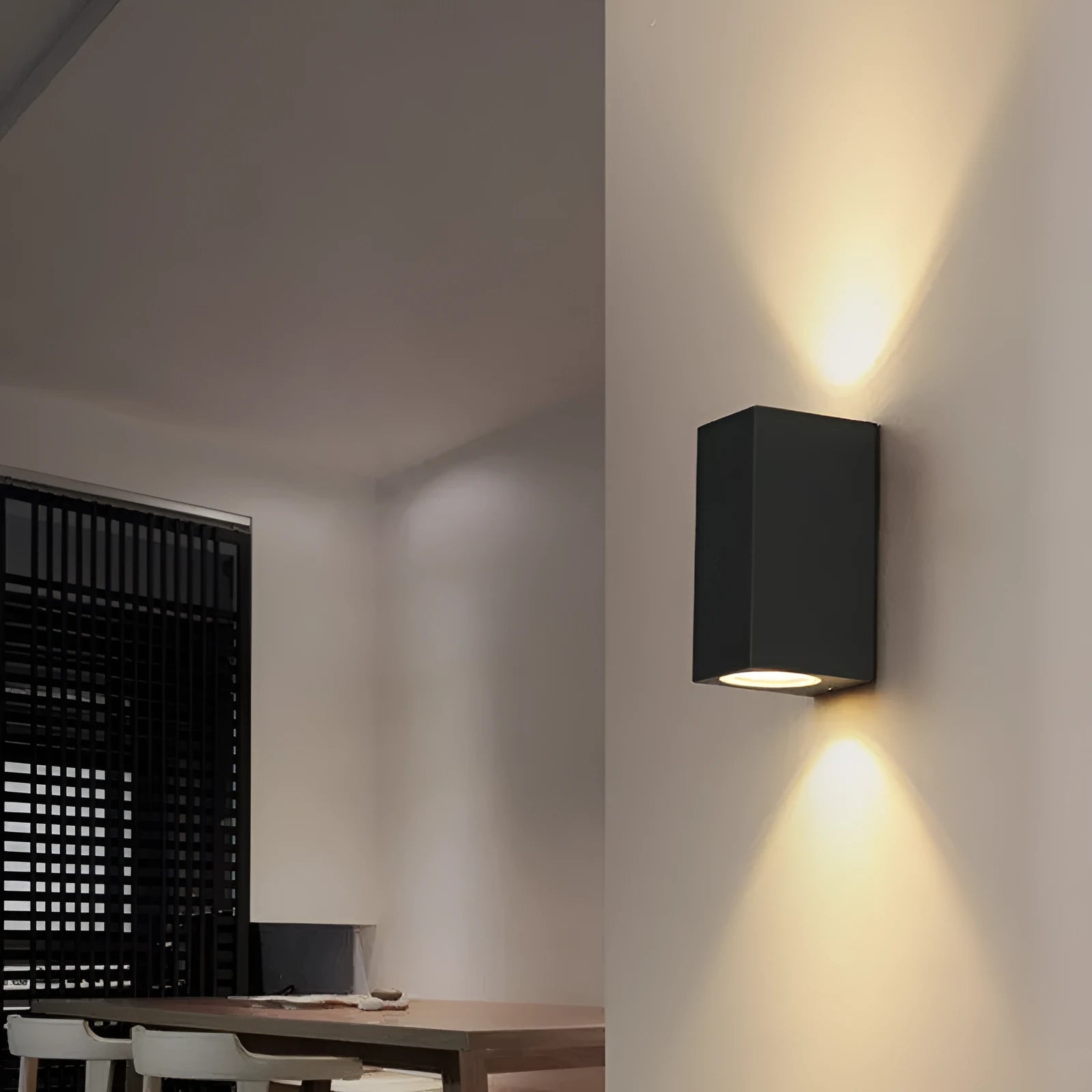 Modern black aluminium and glass wall lamp with silicone rubber detailing and integrated LED light.
