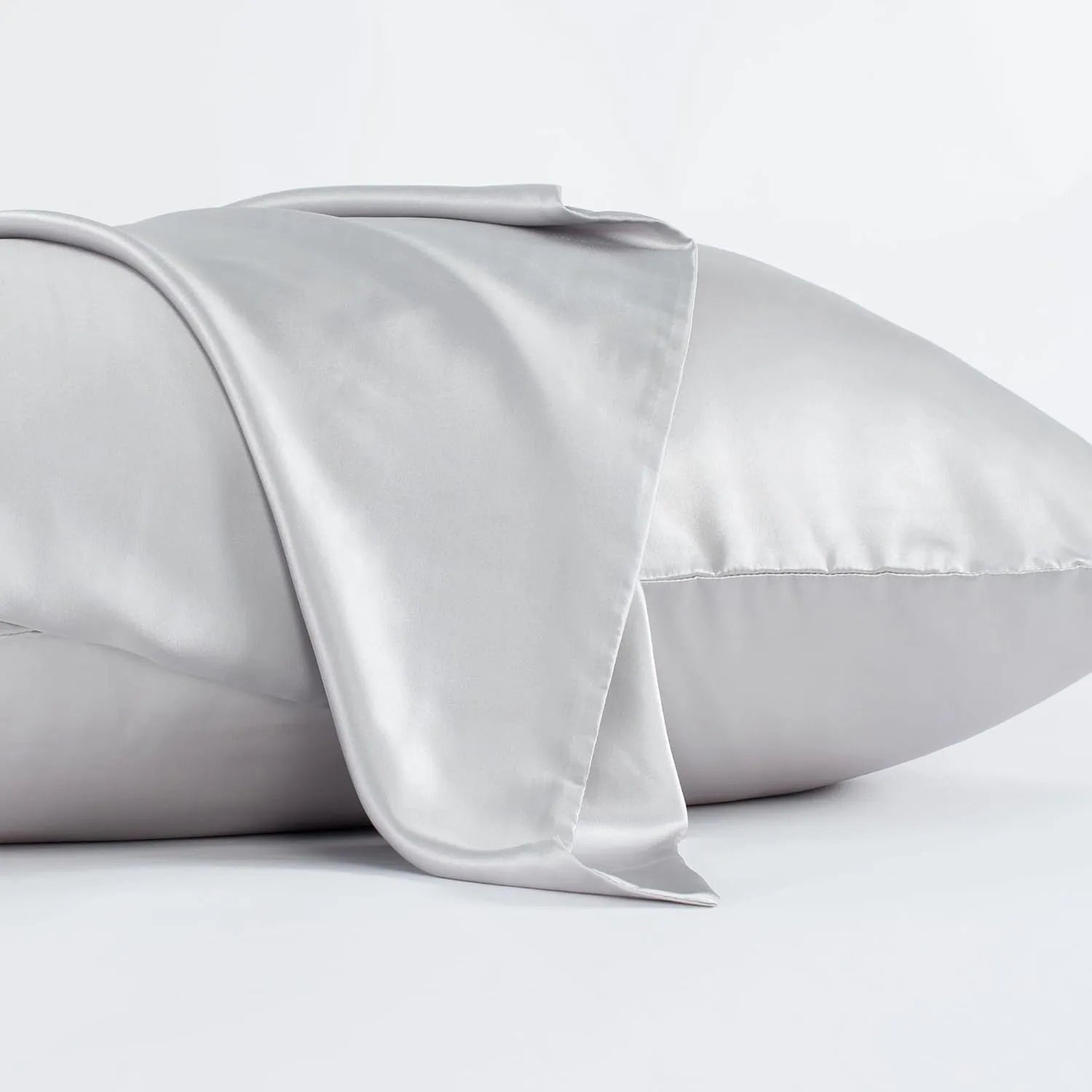 Dark grey mulberry silk pillowcase with envelope closure, shown in a modern bedroom setting.