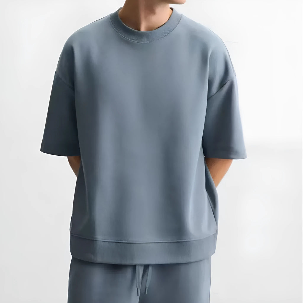 Loose fit short sleeve t-shirt and matching shorts set in blue, shown on a hanger