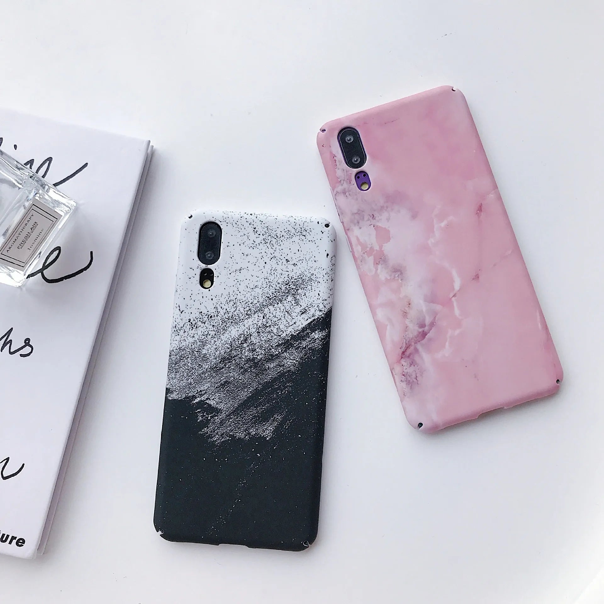 Solid black and solid pink painted phone back covers for Huawei and Honor smartphones on a white background.