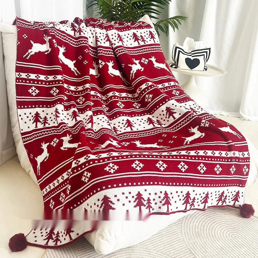 Personalised acrylic Christmas blanket with snowflake pattern draped over a sofa.