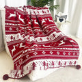 Personalised acrylic Christmas blanket with snowflake pattern draped over a sofa.