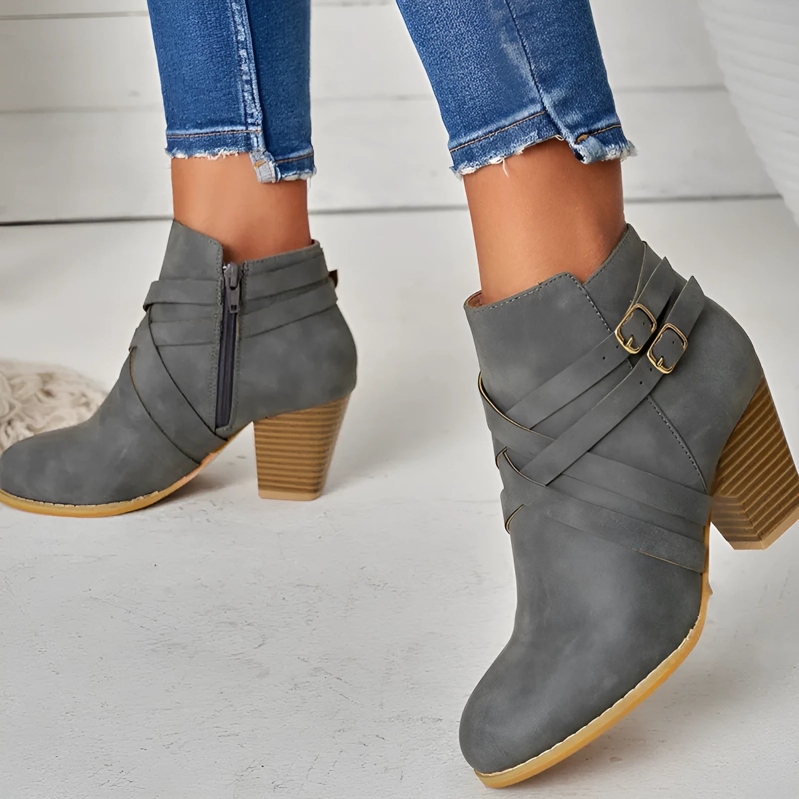 Women's grey ankle boot with 7cm block heel, side zipper, and buckle detail on a plain toe.