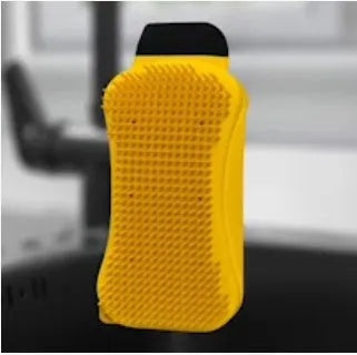 3-in-1 silicone sponge scrubber with built-in soap dispenser, nylon scraper, and squeegee on kitchen counter