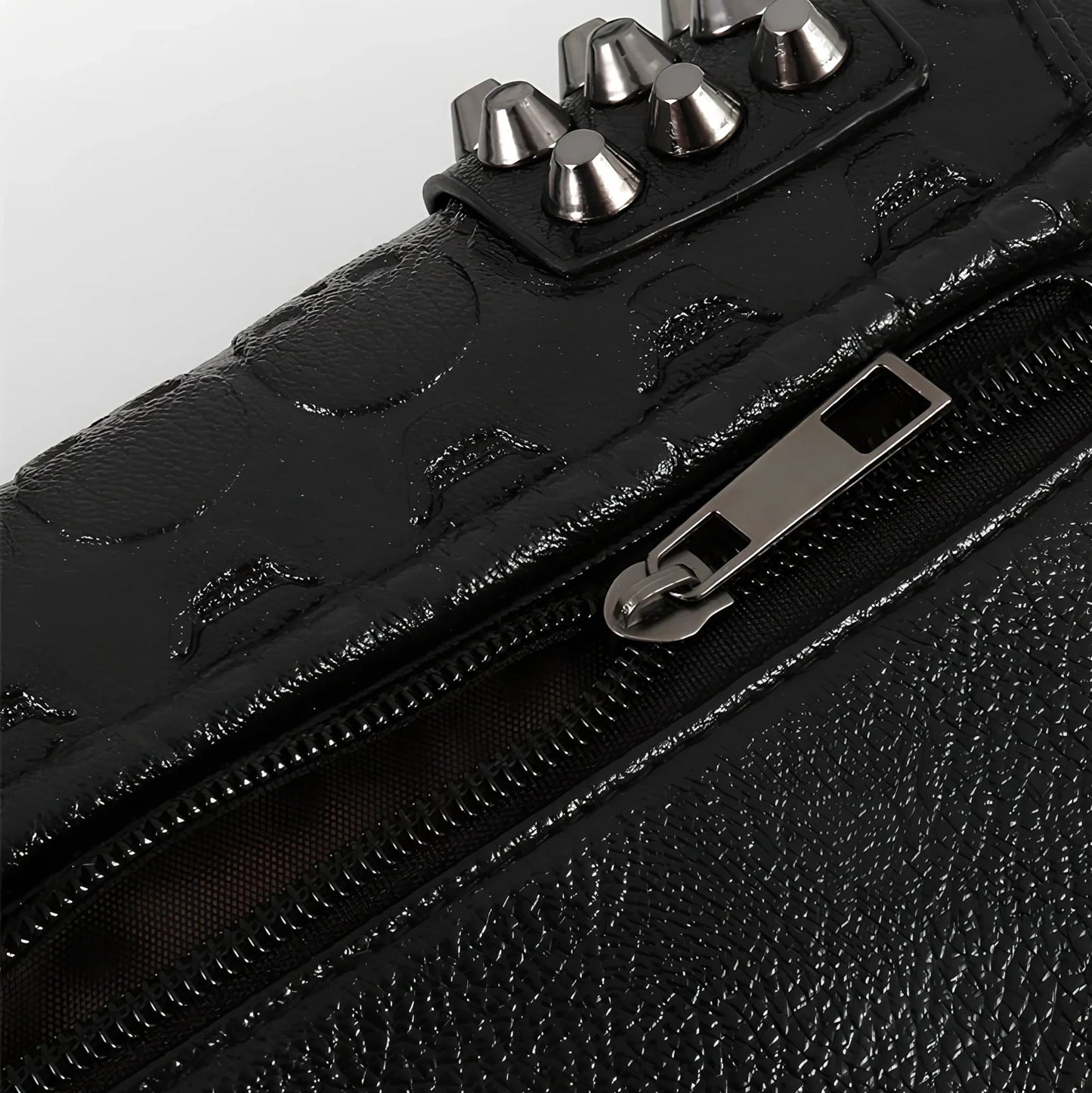 Black Shantou women's messenger bag with rivets, chain handle, and square shape for secure cross-body carry