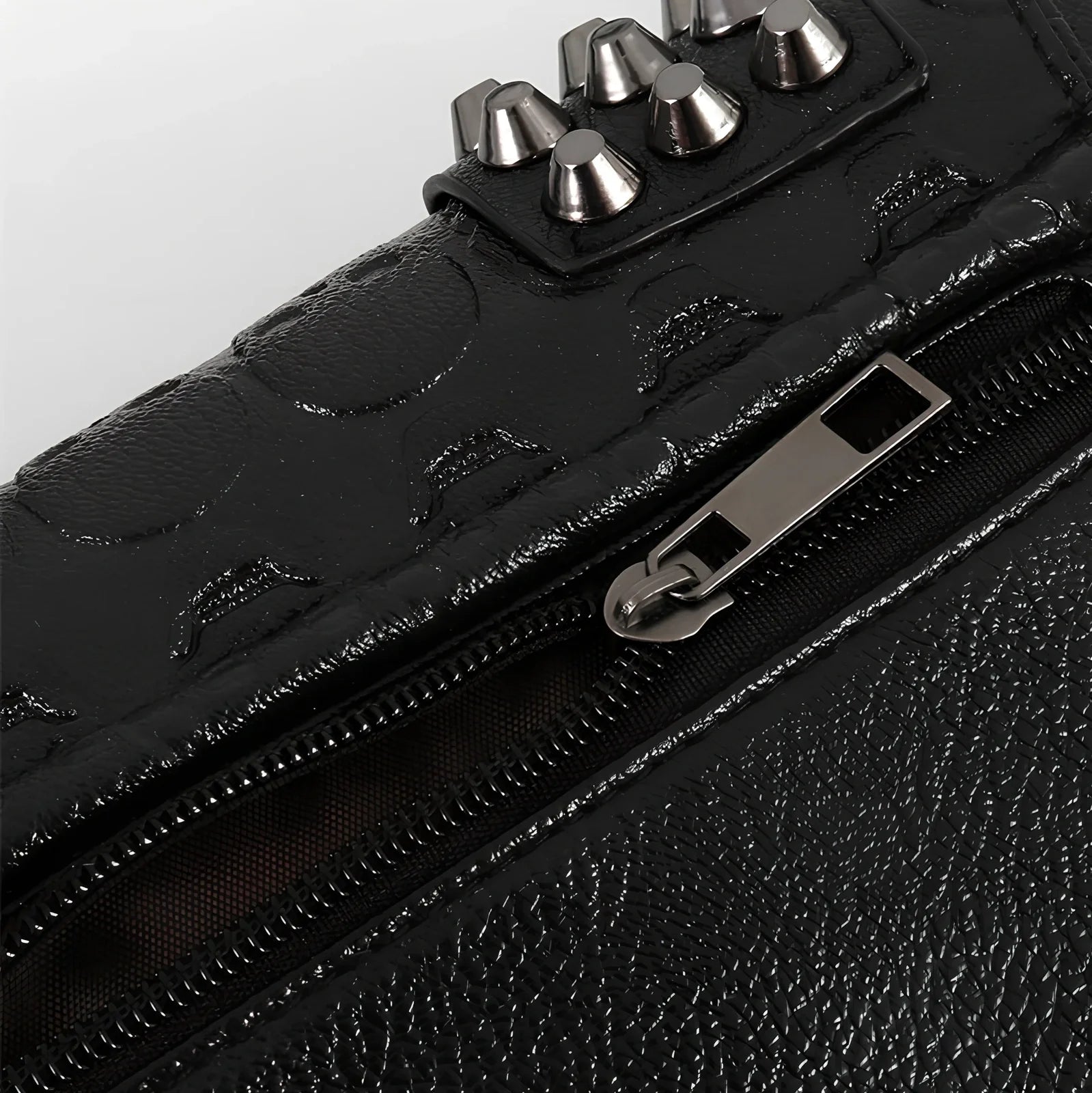 Black Shantou women's messenger bag with rivets, chain handle, and square shape for secure cross-body carry