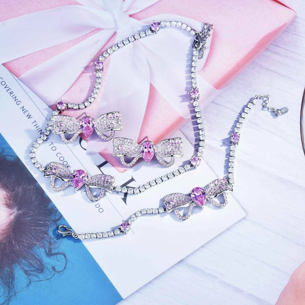 Full diamond bow jewellery set with necklace, bracelet, and ear studs in copper with mixed gem inlay