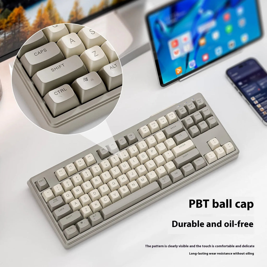Free Wolf M87 wireless Bluetooth dual-mode keyboard shown in one of four colour options: blueberry, cheese, coffee, or shimmer.