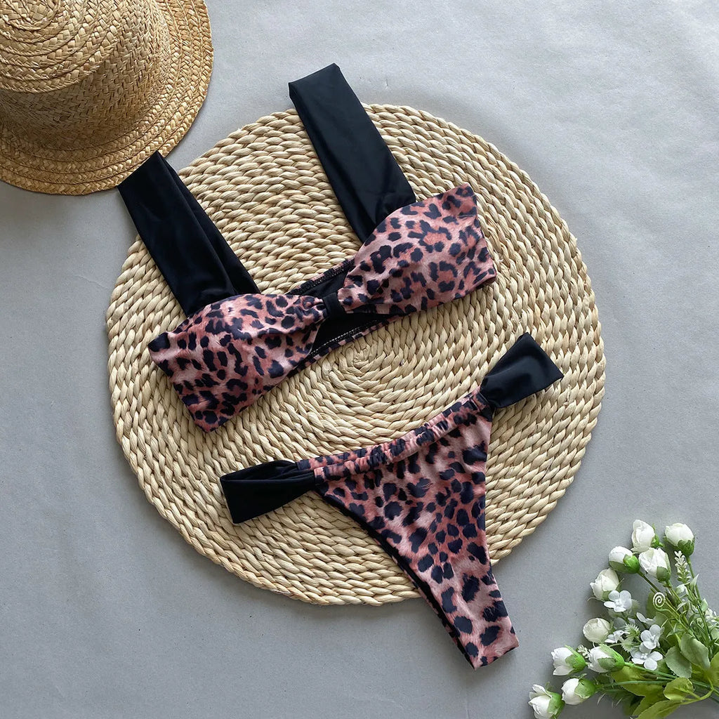 Black women's bikini with leopard print tube top and matching split T-back pant.