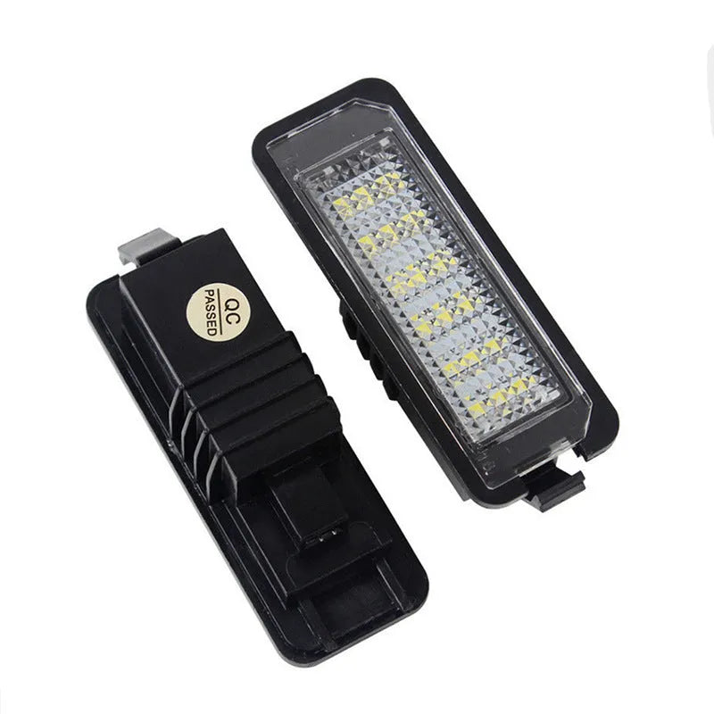 Two Volkswagen LED license plate light bulbs with white LEDs and electrical connectors.