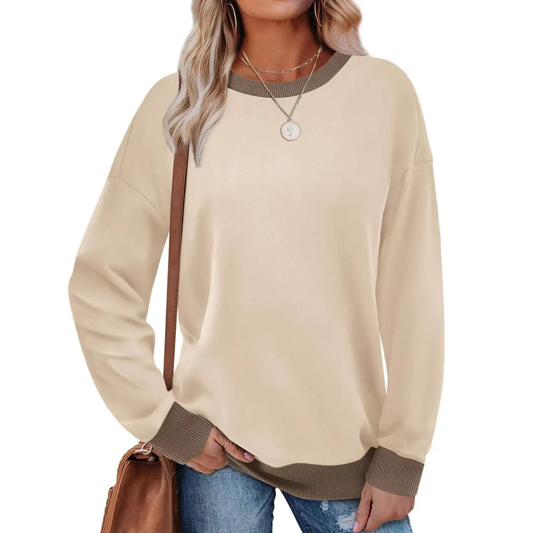 Women's loose round neck striped long sleeve top in apricot colour on a hanger.