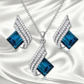 Women's alloy pendant necklace and matching stud earrings set with cross chain and glass accents