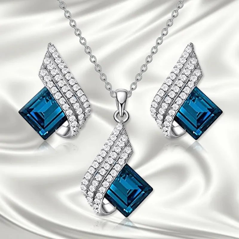 Women's alloy pendant necklace and matching stud earrings set with cross chain and glass accents