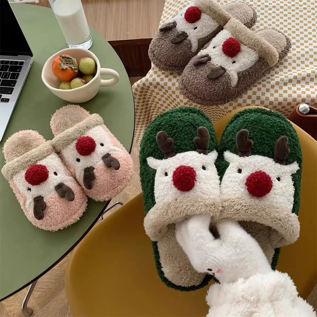 Women's green plush Christmas elk slippers with non-slip PVC sole, shown on a white background.