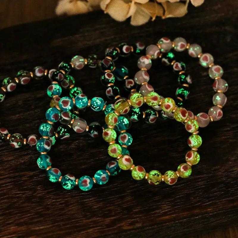 Handmade glass bracelet with swallowing gold beast design and 10mm heart-shaped beads in fluorescent glaze