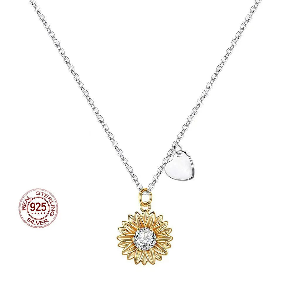 925 sterling silver sunflower necklace with daisy petal details on an adjustable cross chain.