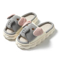 Elephant grey open-toe linen slippers for couples on a plain background.