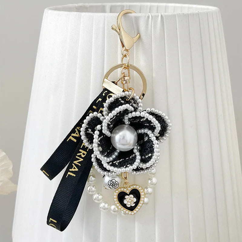Camellia key chain with ribbon and pearl accent in Korean style, available in four colours