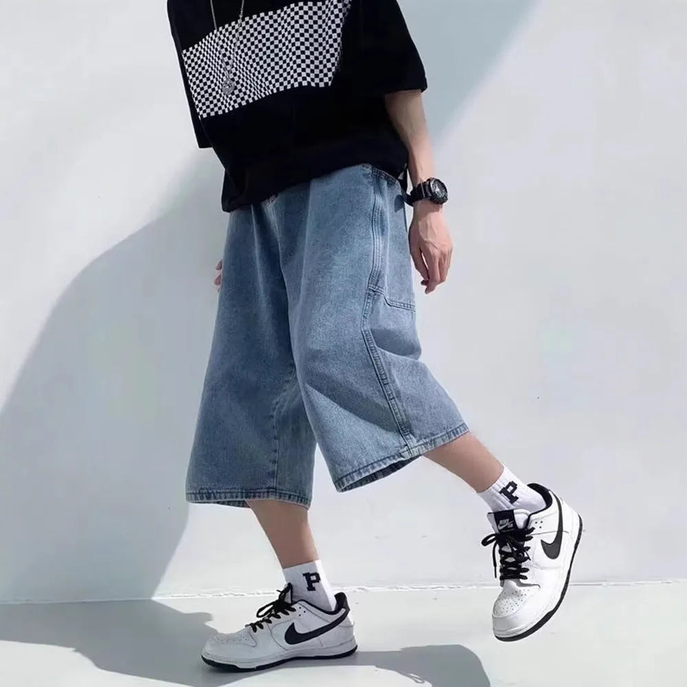 Blue high-waisted men's denim pirate shorts with a cropped length and straight-leg silhouette on a white background.