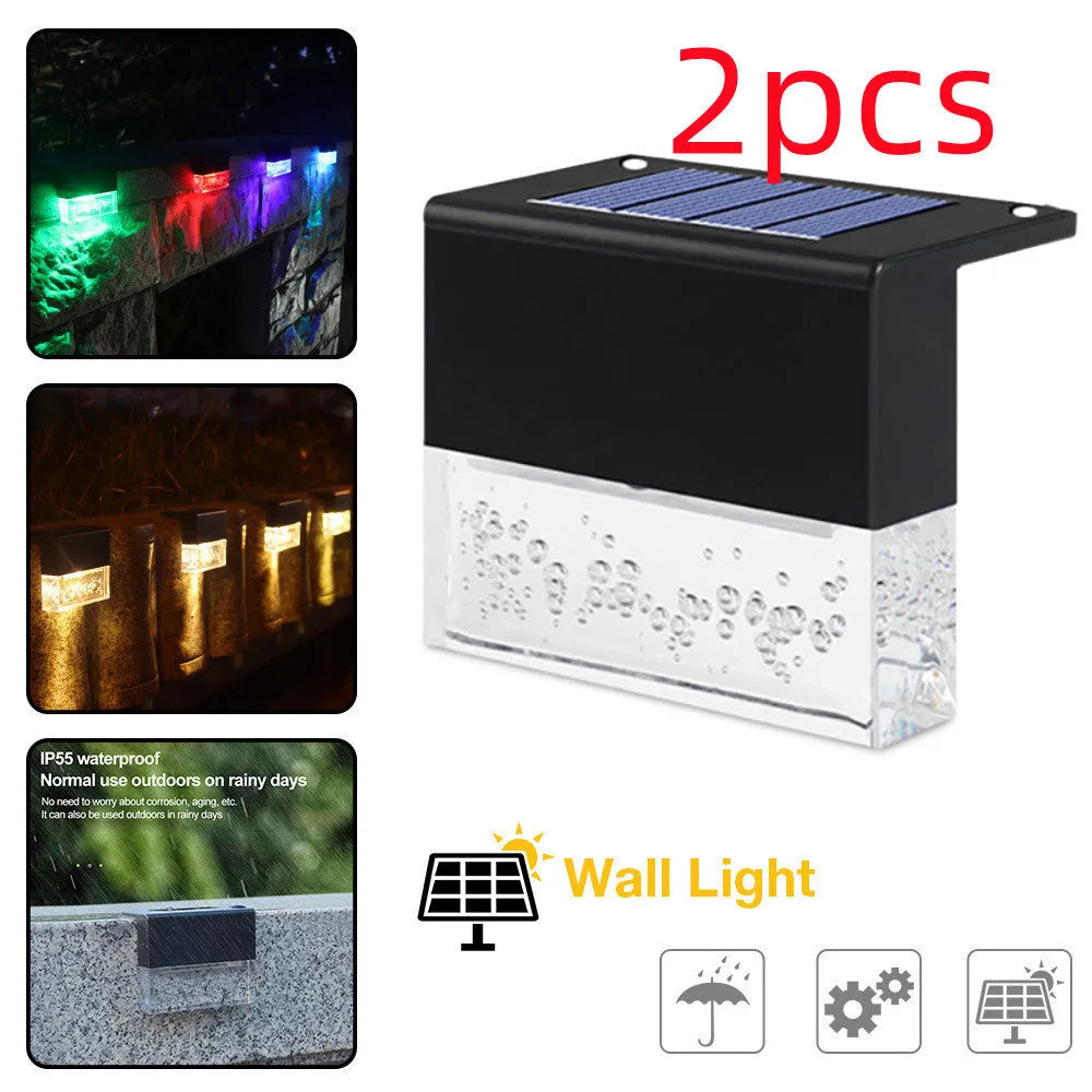 IP65 waterproof solar step light with crystal-like amber cover and RGB LED on a garden path