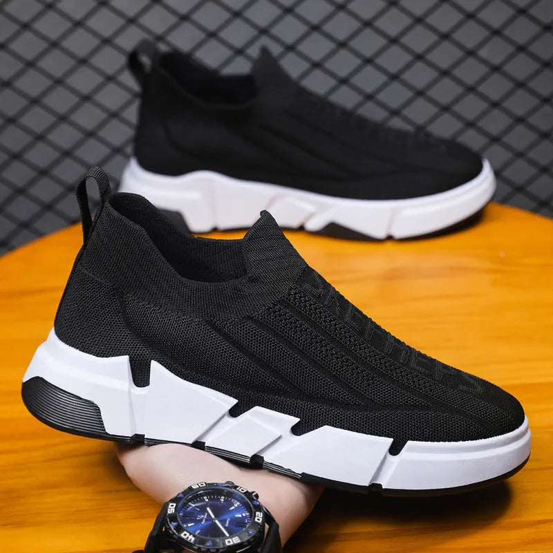 Men's slip-on casual sports shoes with black flyknit mesh upper and sock cuffs, flat PVC sole