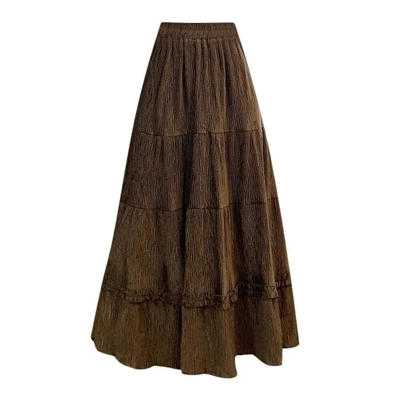 Women's milky white corduroy A-line midi skirt with an elastic waistband, laid flat.