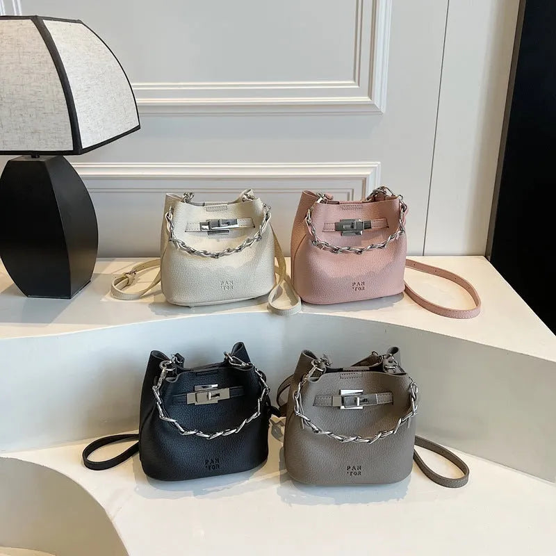 Soft PU leather retro bucket shoulder bag with chain detail in four colour options.