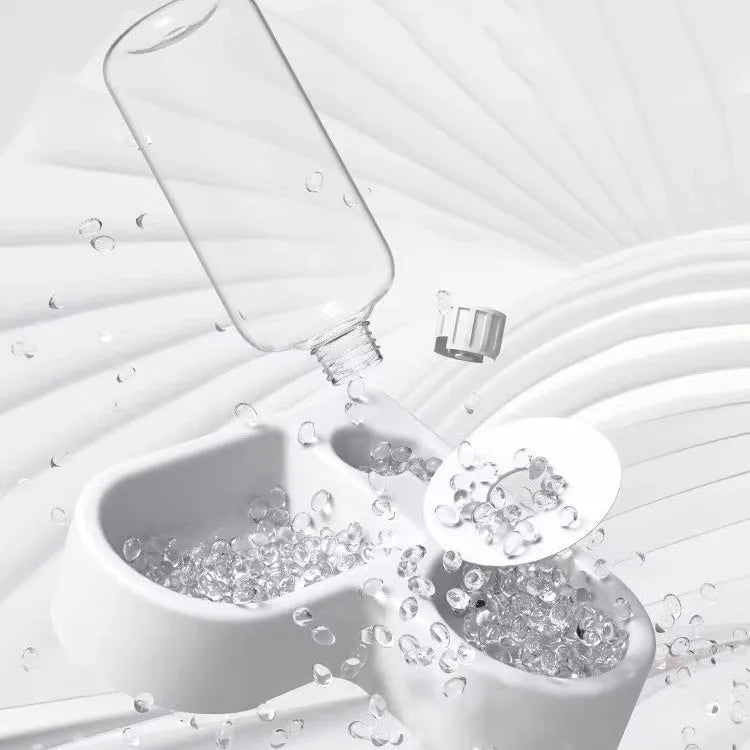 White cat water fountain with flower-shaped top and LED light on a kitchen counter