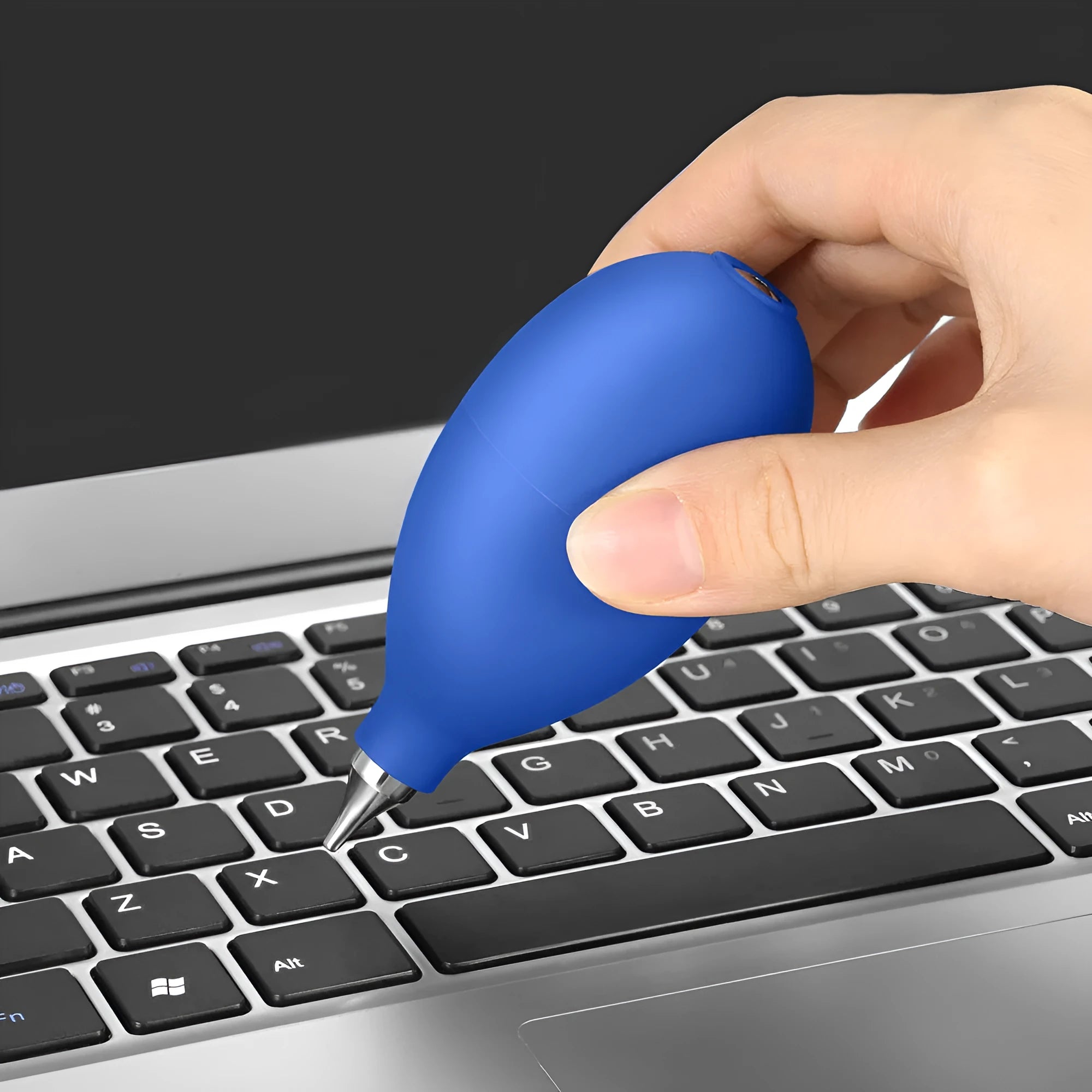 Blue rubber dust removal air blower cleaning tool shown next to a mobile phone.