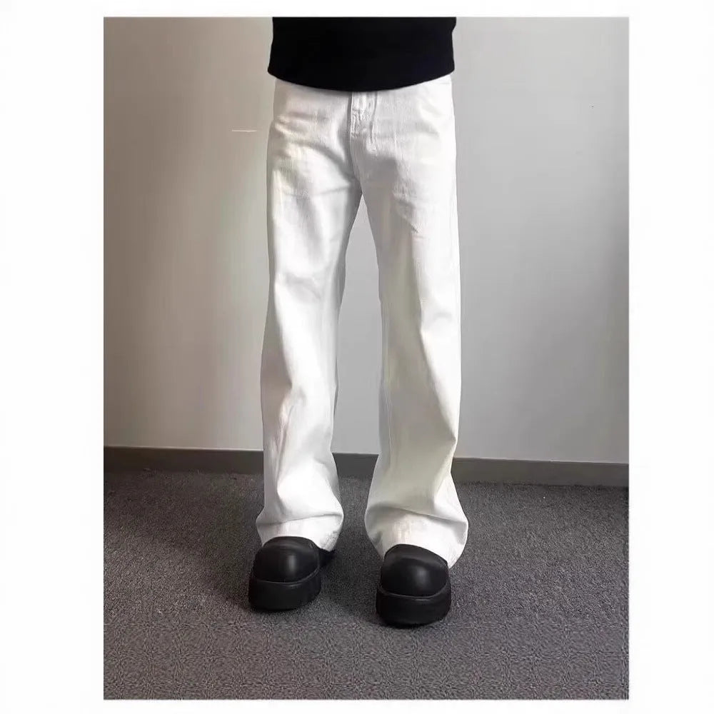 Men's white straight-leg cotton denim jeans on a hanger, showing the mid waist and wide leg opening.