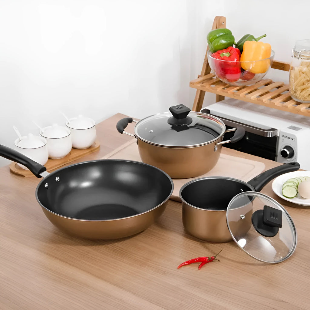 Three-piece cast iron cookware set showing a soup pot, milk pot, and wok with light luxury finish.