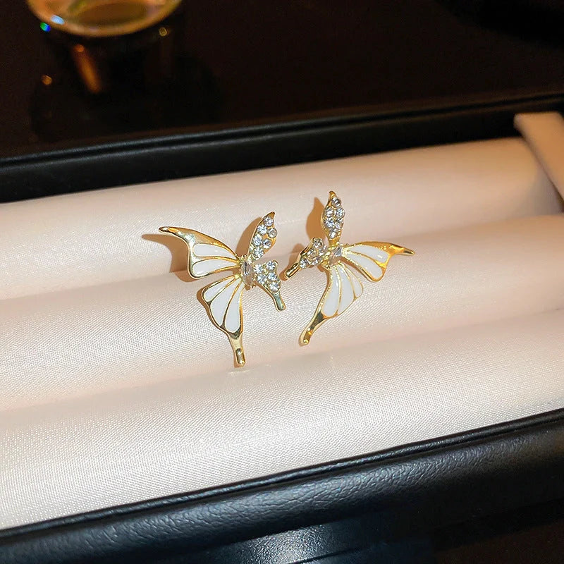 Rhinestone-dripped butterfly stud earrings in alloy with diamond treatment, available in colors A128 and A129