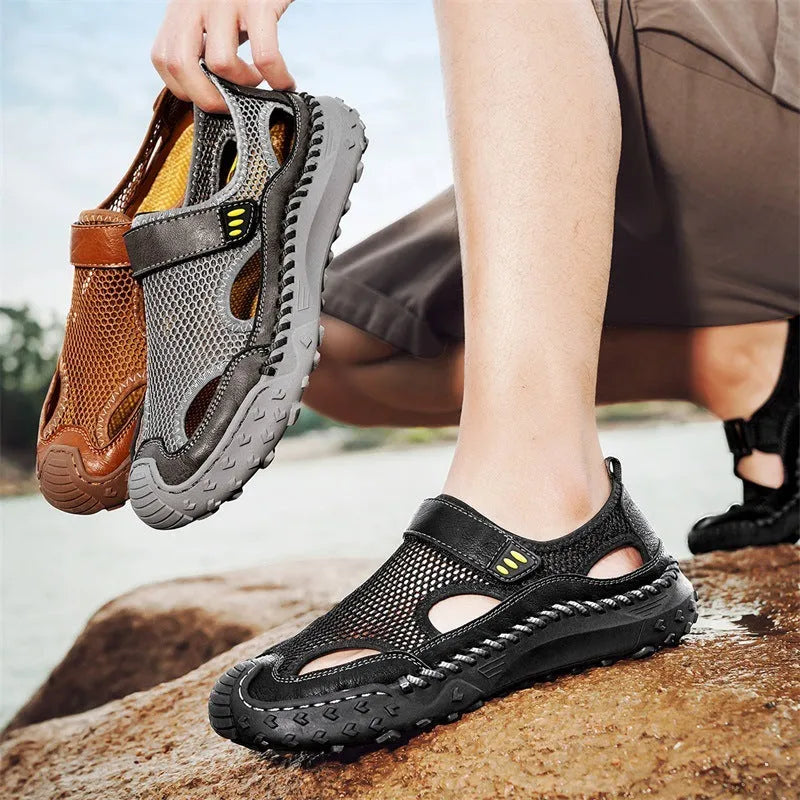 Men's black casual sandals with a mesh upper and velcro strap on a rubber sole.