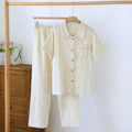 Women's loose-fit short-sleeved trousers and top in washed cotton gauze, shown in a floral or plaid pattern.