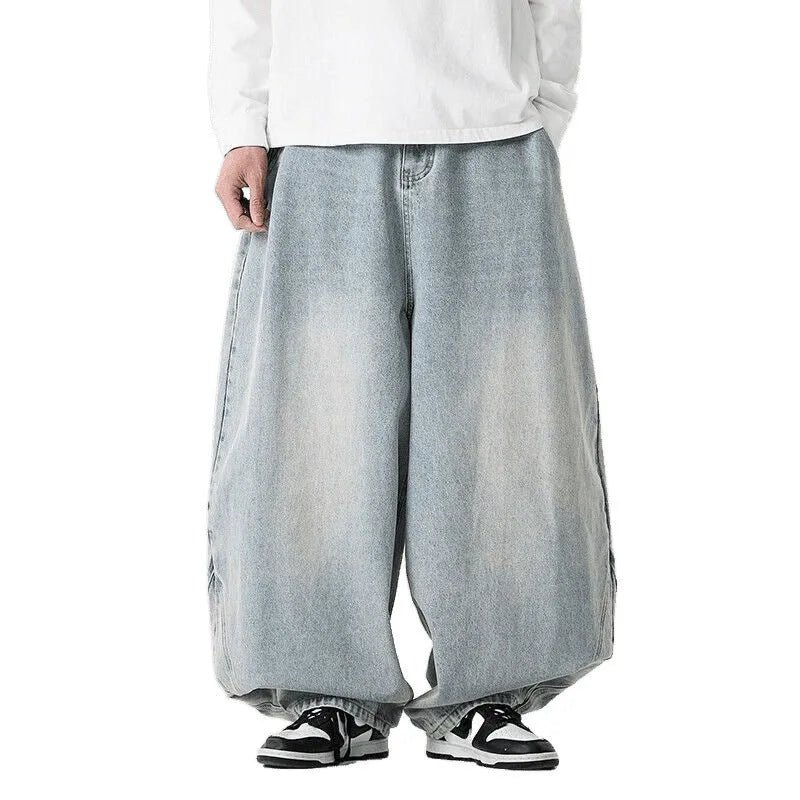 Men's plus-size light blue wide-leg denim jeans with a loose, baggy fit and straight legs on a hanger.