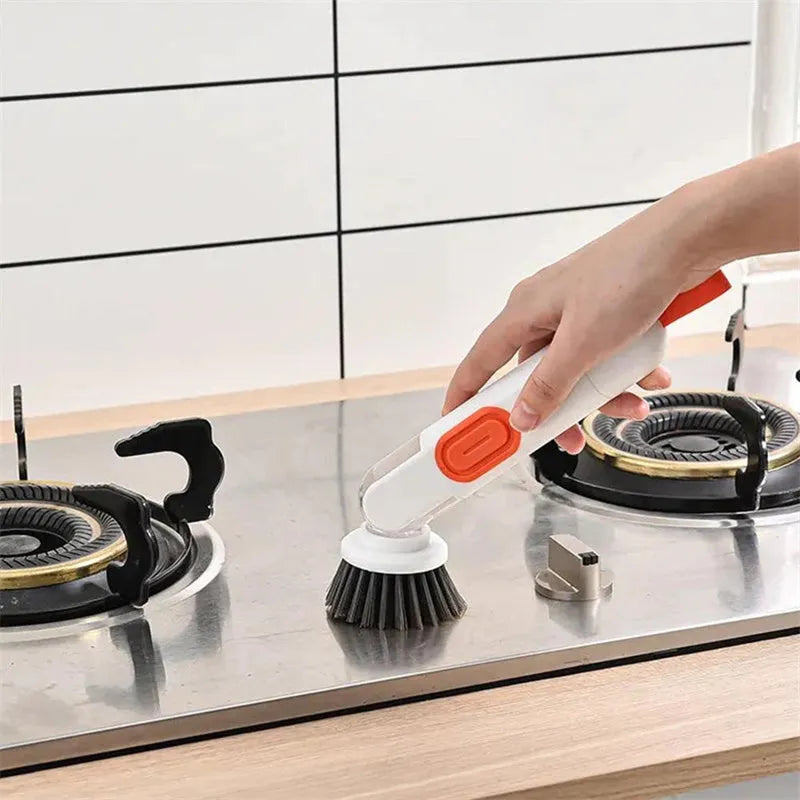 White and red long-handle kitchen cleaning brush with integrated soap dispenser button and two brush heads.