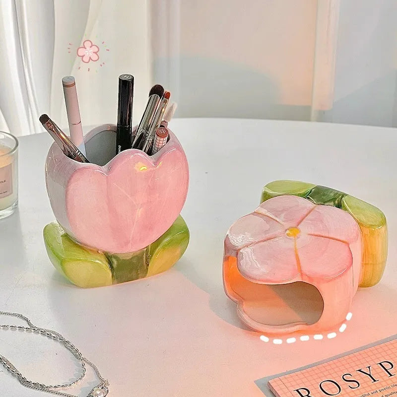 Ceramic tulip-shaped pen holder and storage box in a floral colour pattern on a desk.